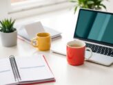 A workspace with a planner and laptop on a desk.